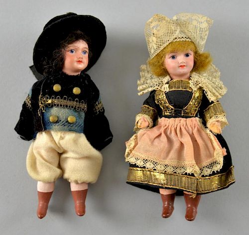 Pair of bisque headed dolls in national dress, 12.5cm high,