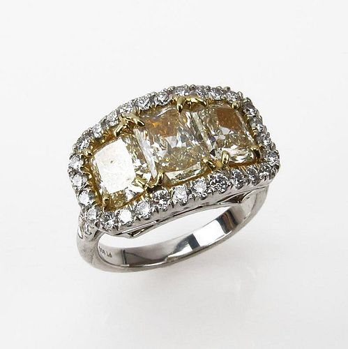 EGL Certified 2.91 Carat Radiant Cut Fancy Light Yellow Diamond and Platinum Three Stone Ring accented throughout with .72 Ca