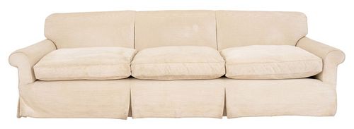 Three seater white ribbed cotton chenille upholstered sofa, with tripartite channeled back, scrolling arms, drop in seat cushions and skirted legs. 33