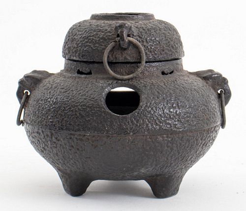 Diminutive Japanese cast iron two-part incense burner, each spherical section pierced and with rings in the form of small handles, the lower part on t