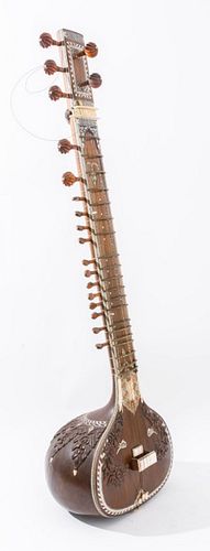 Indian 'Rikhi Ram' carved rosewood sitar enhanced with bone motifs, with New Delhi based maker plate. 49.5" H x 14.5" W x 12" D.