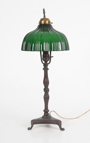 A Cast Iron and Cased Glass Table Lamp
