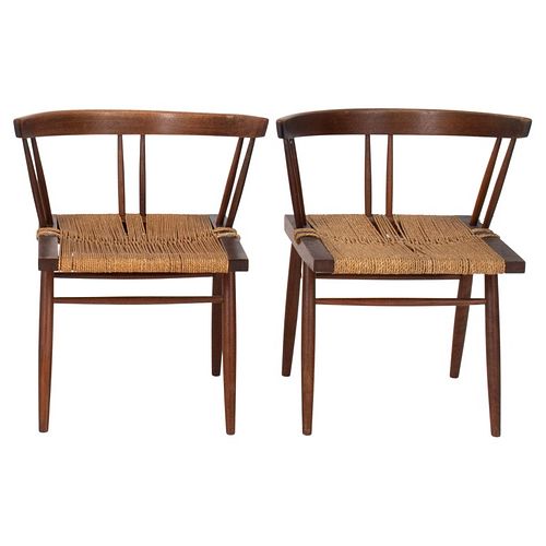 Pair of George Nakashima (American, 1905-1990) grass seated chairs, designed 1940s, of typical form in black walnut with rounded back above spindles o