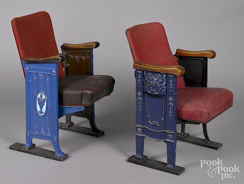 Two theater seats with ornate cast iron supports, one with two decorated sides