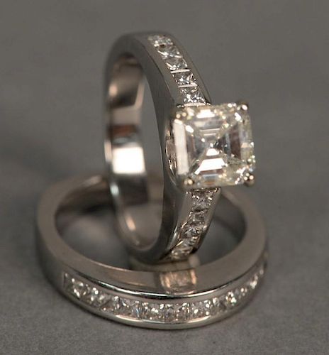 Two piece set, 14K white gold diamond ring with center asscher cut diamond 1.50cts. flanked by five diamonds on either side a