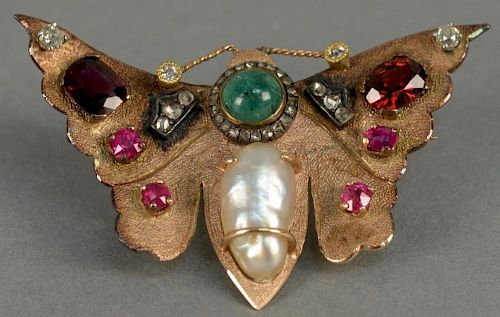 14K butterfly pin set with diamonds, rubies, emerald, and pearl. 
wd. 2 1/4in. 
14.3 grams