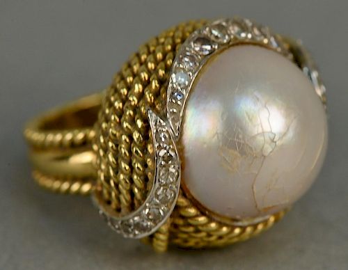 18K gold ring set with large pearl set with twenty-three diamonds, eighteen are in crescent design (pearl with small chip). 
