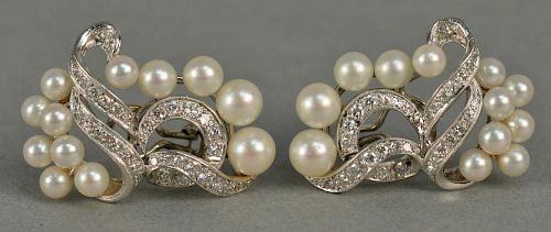 14K white gold clip on earrings, free form design, each set with twelve pearls and thirty-six diamonds. 
total weight 14.3 gr
