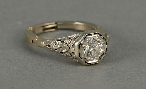 14K gold ring set with center diamond approximately .90cts. in a filigree setting.