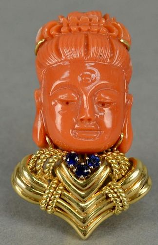 18K gold brooch/pendant with red coral carved head having sapphires and gold collar.  ht. 1 1/2in.