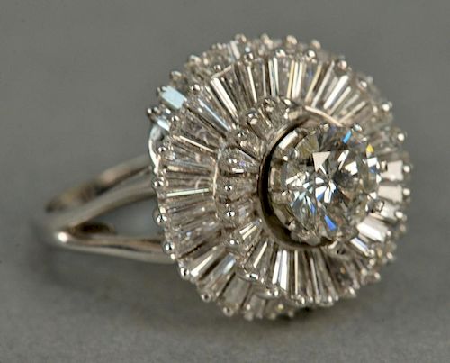 Platinum cocktail ring with center diamond approximately 1.3cts with a surround of baguette diamonds approximately 1ct.