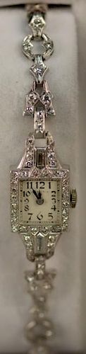 Hamilton platinum ladies wristwatch mounted with diamonds in watch and band, band marked 14K.  total weight 20.6 grams