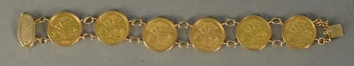 Gold coin bracelet set with six sovereign gold coins in 14K bracelet. 
total weight 36.1 grams