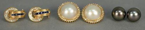 Three pairs of gold pierced earrings, one pair set with baguette diamonds and blue sapphires and two pairs of pearl earrings.
