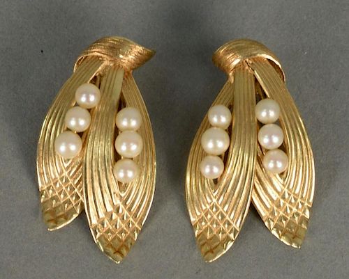 Pair of 14K clip earrings, leaf design, each set with six small pearls.