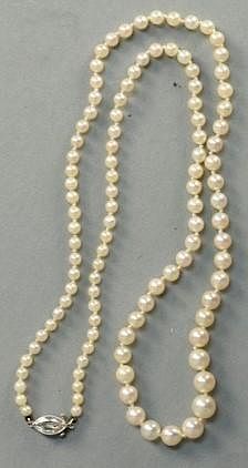 Pearl necklace with graduated pearls and marquis diamond clasp.