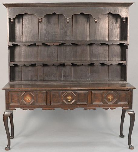 Oak Welsh cupboard in two parts, upper section having cornice molding over open shelves on lower section having three drawers
