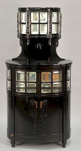 In the manner of Josef Olbrich ebonized wood and glass cabinet, center and top compartment with mirrored back, circa 1910.  (