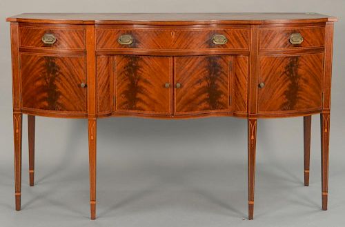Margolis mahogany sideboard having serpentine top over conforming case with three drawers over four doors all set on square t