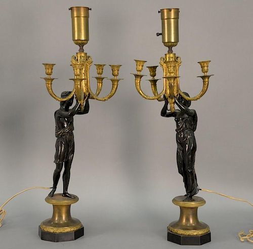 Pair of gilt and patinated bronze four light figural candelabra, late 19th century male and female classical figures holding