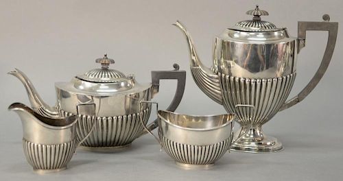 Four piece English silver tea and coffee set with wood handles. 
ht. of pot 10in. 
55.3 total troy ounces