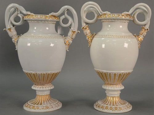 Pair of Meissen porcelain urns with snake handles terminating in foliate stalks, overall white with gilt handle and rims, cro