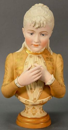 Bisque porcelain bust of an elegant young maiden wearing a gold and tan shirt with gilt collar. 
ht. 16in.
