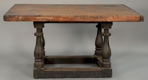 Early table having a slab top of one board on a base with turned legs and box stretchers, probably Spanish 16th-17th century 