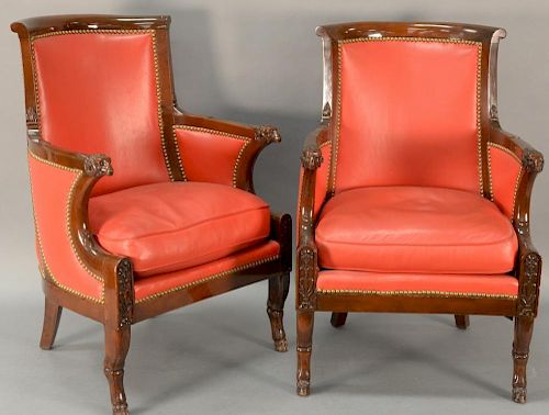 Pair of mahogany fautoil, each with rounded backs and carved ream's head hand supports set on animal legs with hoof feet, eac