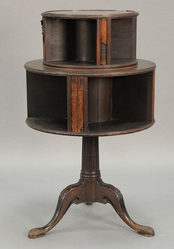 George IV mahogany two tier revolving book stand, each revolving tier with faux books, all set on fluted column on tripod bas