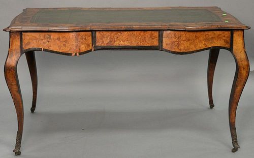 Louis XV style writing table having shaped top with inset leather writing surface surrounded by marquetry inlay over conformi