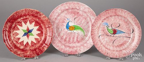 Three red spatter plates with peafowl and star