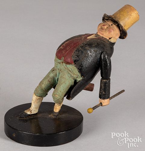 Carved and painted figure of a drunkard