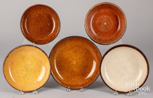 Five redware plates and shallow bowls, 19th c.