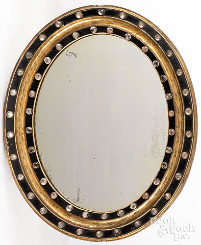 Victorian gilt and ebonized oval mirror