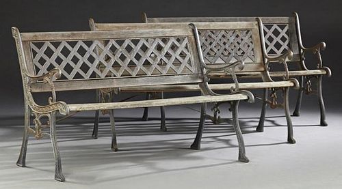 Three French Cast Iron and Mahogany Garden Benches, early 20th c., with a latticed back over scrolled arms and a slatted seat