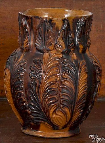 Unusual Pennsylvania redware pitcher, 19th c., with relief foliate decoration, 7'' h.