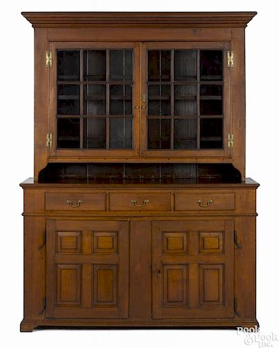 Pennsylvania walnut two-part Dutch cupboard, ca. 1790, with a boldly molded cornice and base