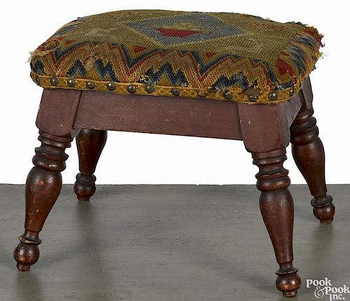 Painted splay leg stool, 19th c., with a needlework cover and an old red surface, 8 1/2'' h.