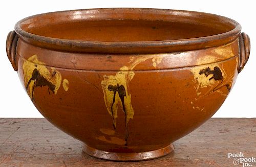 Large redware bowl, 19th c., with yellow and brown slip splashes, 7'' h., 12 1/4'' dia.