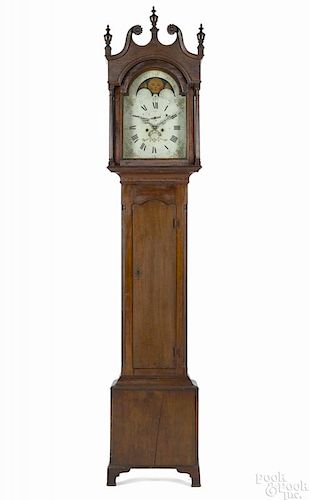Pennsylvania walnut tall case clock with an eight-day movement, a painted face, and a moonphase