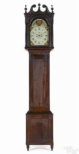 Pennsylvania walnut tall case clock, early 19th c., the eight-day movement with a painted face