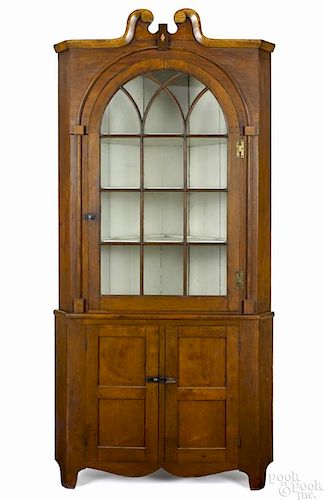 Pennsylvania cherry two-part corner cupboard, early 19th c.
