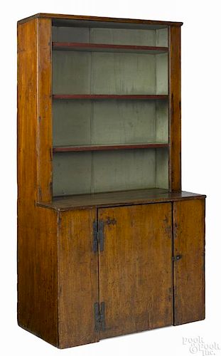 Pine one-piece stepback cupboard, early 19th c., with an open shelf top, 68 1/4'' h., 37'' w.