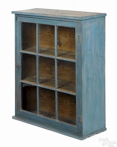 Painted pine and walnut hanging cupboard, 19th c., retaining an old blue surface, 37 1/2'' h.