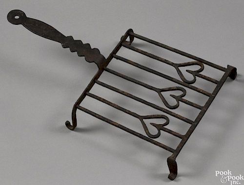 Wrought iron trivet, 19th c., with a heart motif, 17 1/2'' l.