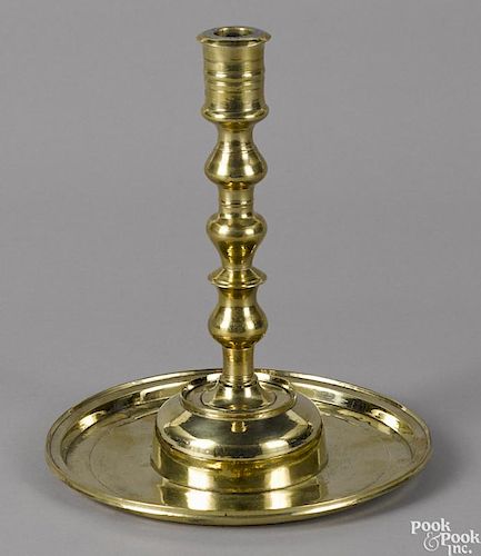 Large Gothic brass candlestick, 17th c., with an oversized drip pan, 10'' h.