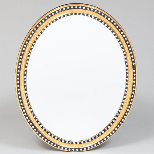 Contemporary Irish Ebonized and Parcel-Gilt Oval Mirror, in the George III Style