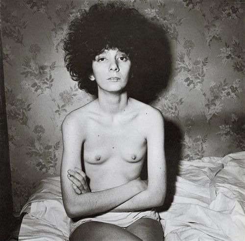 Diane Arbus, Girl sitting on her bed with her Shirt, 1948