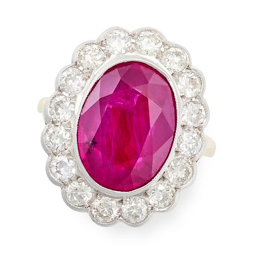A FINE RUBY AND DIAMOND CLUSTER RING in 18ct yellow gold and white gold, set with an oval cut rub...